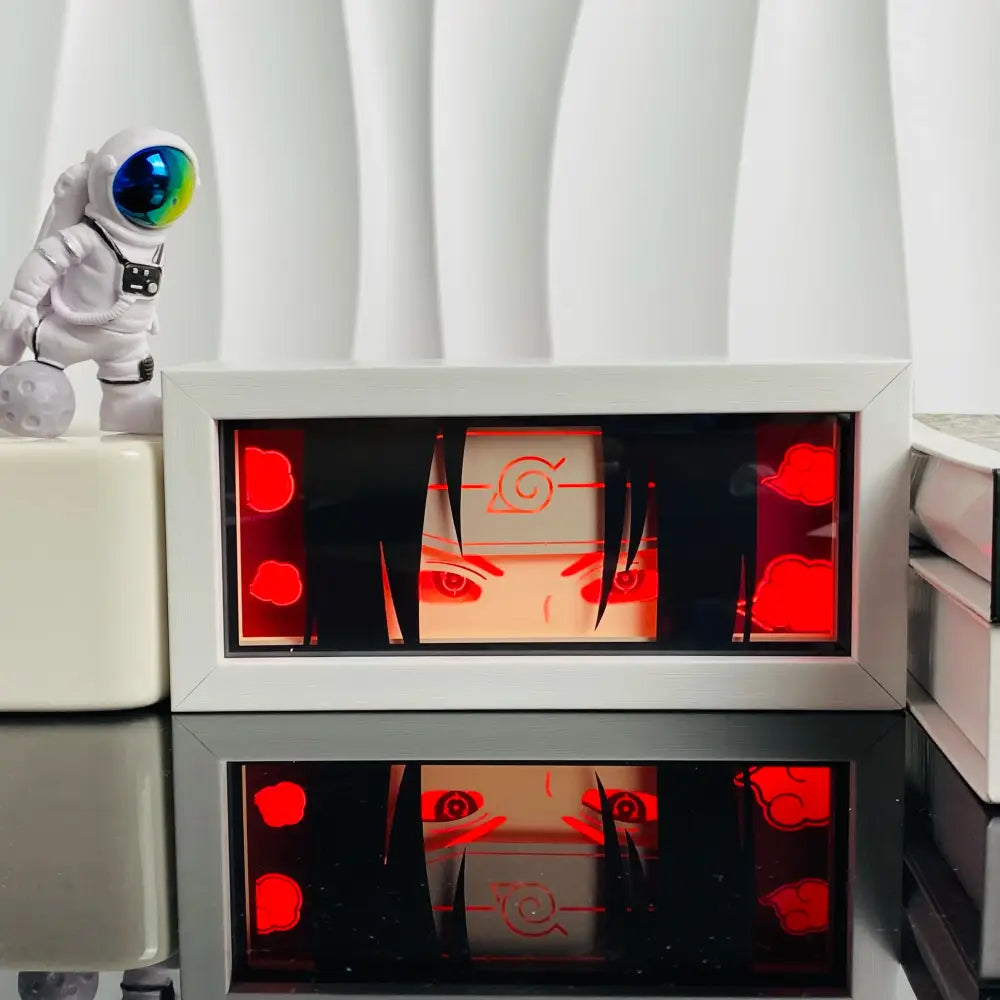 White framed naruto anime led shadow light box with red glowing cloud eye motifs and black silhouette design wood lamp