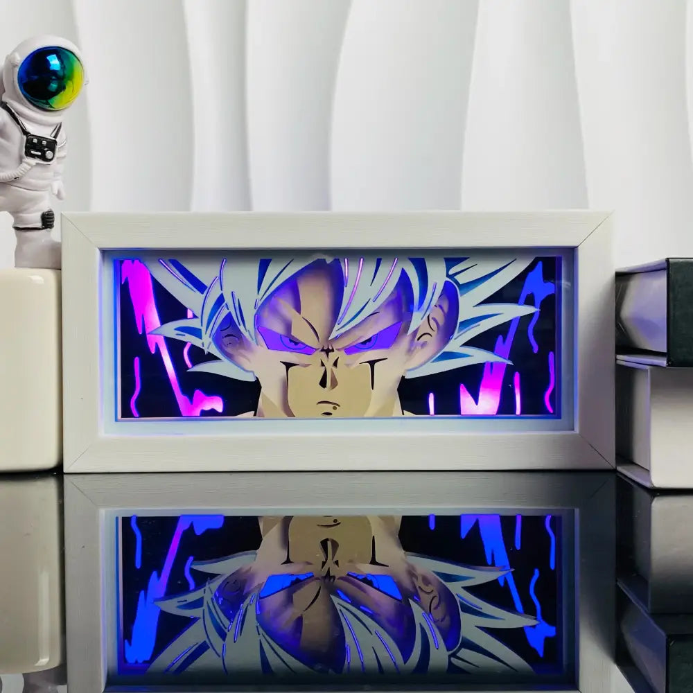 White-framed anime led shadow light box with glowing purple and blue spiky hair character in paper cut wood frame