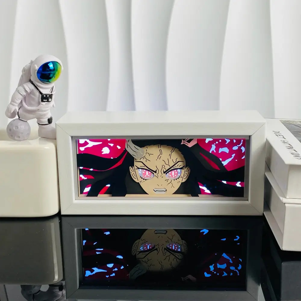 White-framed anime led shadow light box with glowing pink-eyed character on red background in paper cut wood frame