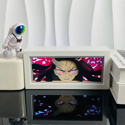 White-framed anime led shadow light box with glowing pink-eyed character on red background in paper cut wood frame