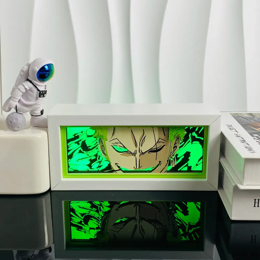 White rectangular anime led shadow light box with glowing green anime character face in paper cut wood frame