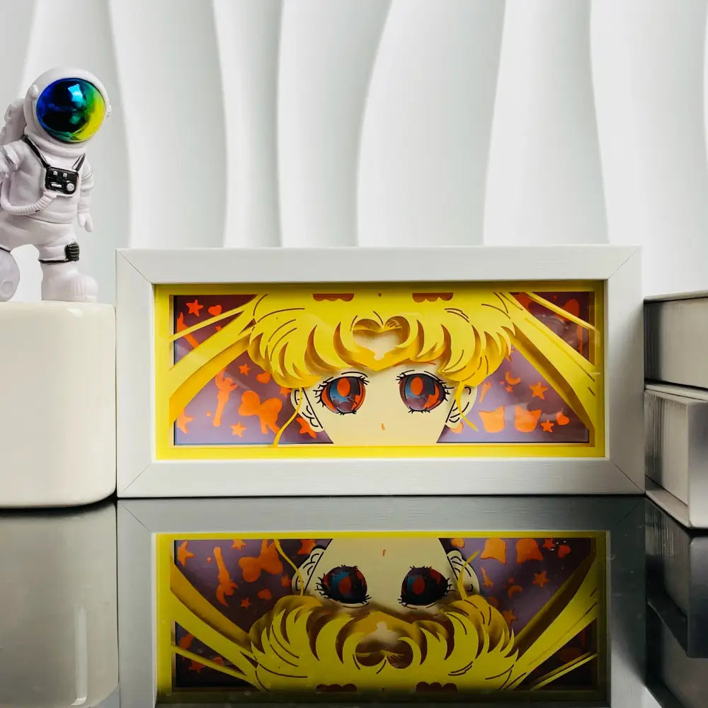 White-framed anime led shadow light box featuring paper cut sailor moon with golden hair and red eyes against yellow border