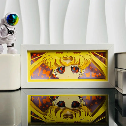 White-framed anime led shadow light box featuring paper cut sailor moon with golden hair and red eyes against yellow border