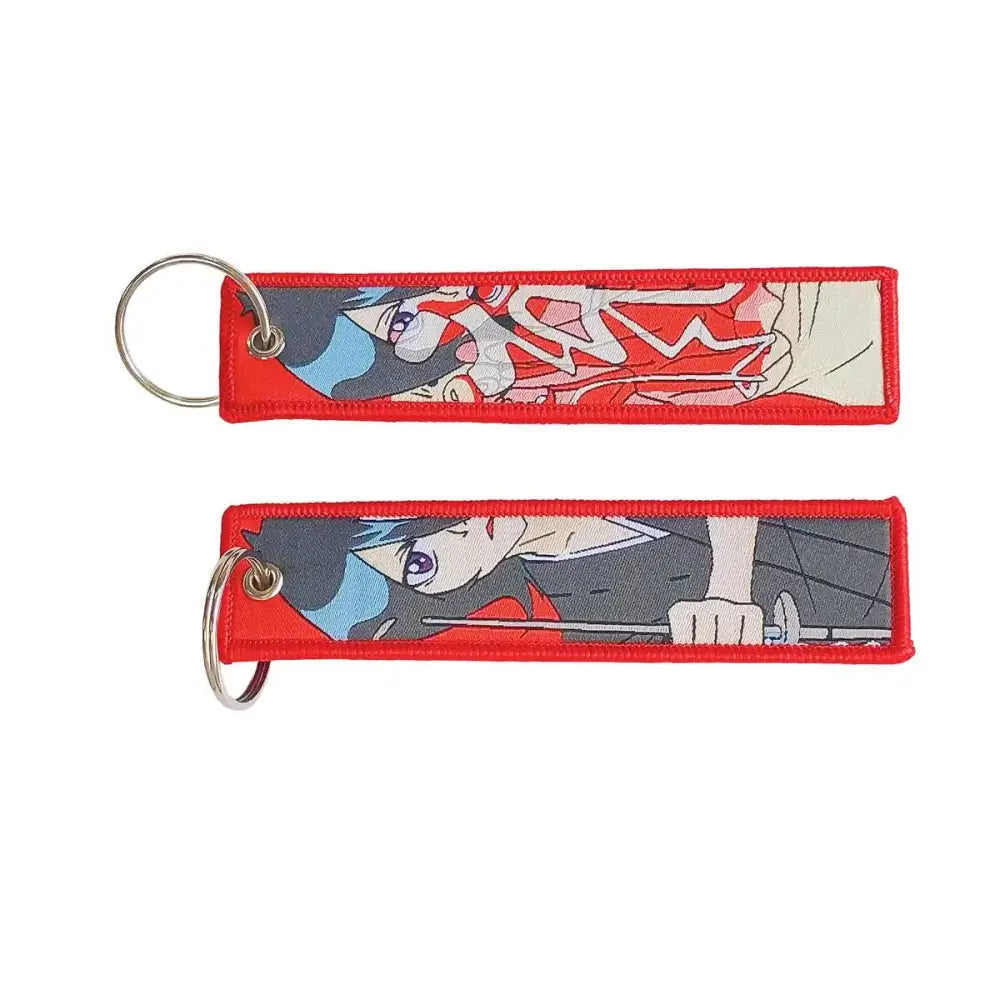Red embroidered anime lock keychain with anime character design and silver metal jet tag ring