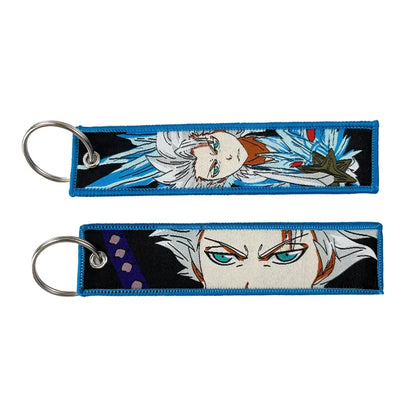 Blue embroidered anime lock keychain featuring white hair anime character designs with teal eyes jet tag
