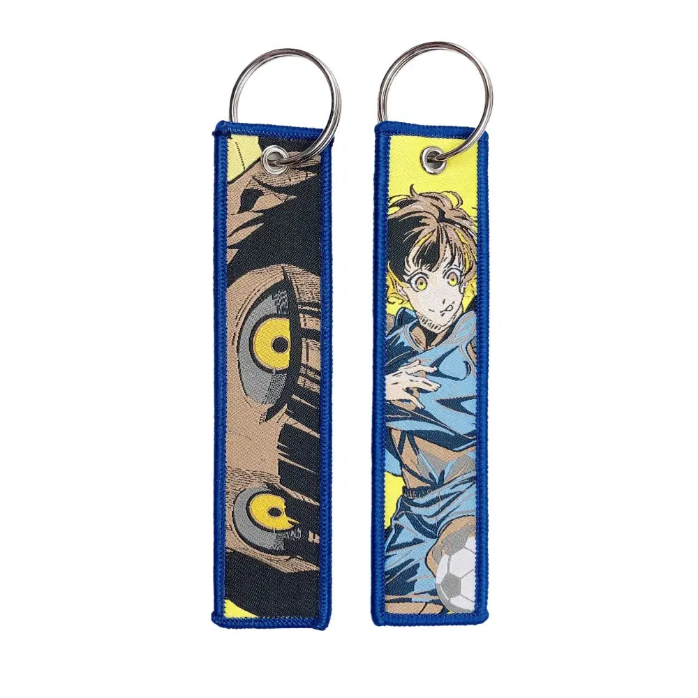 Blue embroidered anime lock keychain jet tag with yellow-eyed characters and soccer ball design