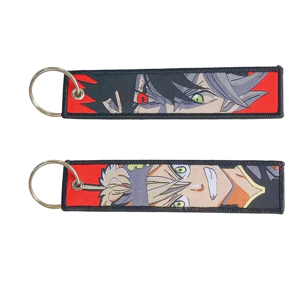 Two embroidered anime lock keychains with vibrant red black and gray jet tag designs for fans and collectors