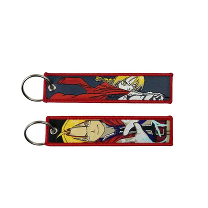 Two embroidered anime lock keychains with red borders and metallic rings featuring anime characters jet tag design