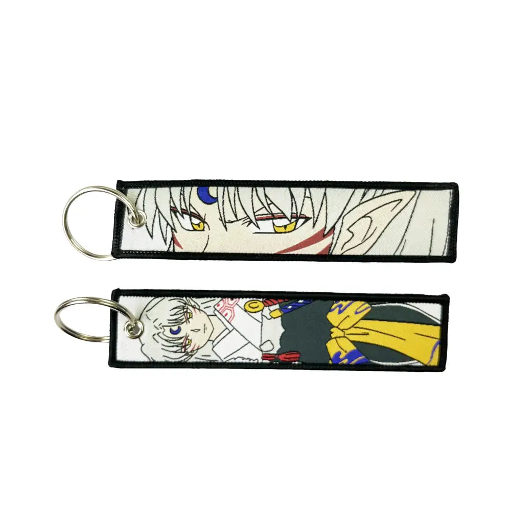 Two rectangular embroidered anime lock keychains featuring a white-haired character and a colorful anime lock design