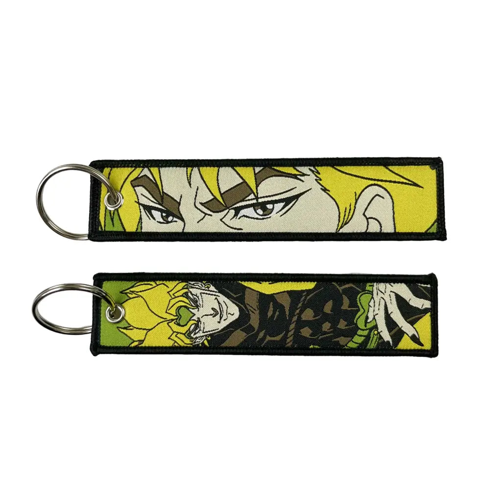 Two embroidered anime lock keychains with vibrant yellow hair and black outlines on a bright green background