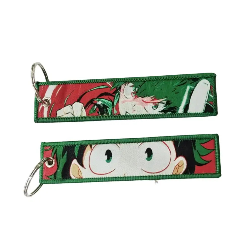 Green-bordered anime lock keychain with embroidered jet tag featuring anime character designs on red and white backgrounds