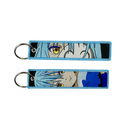 Blue embroidered anime lock keychain featuring a jet tag with an anime character with light blue hair and golden eyes