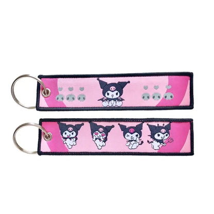 Pink and black embroidered anime lock keychain jet tag featuring kuromi in various poses on fabric material
