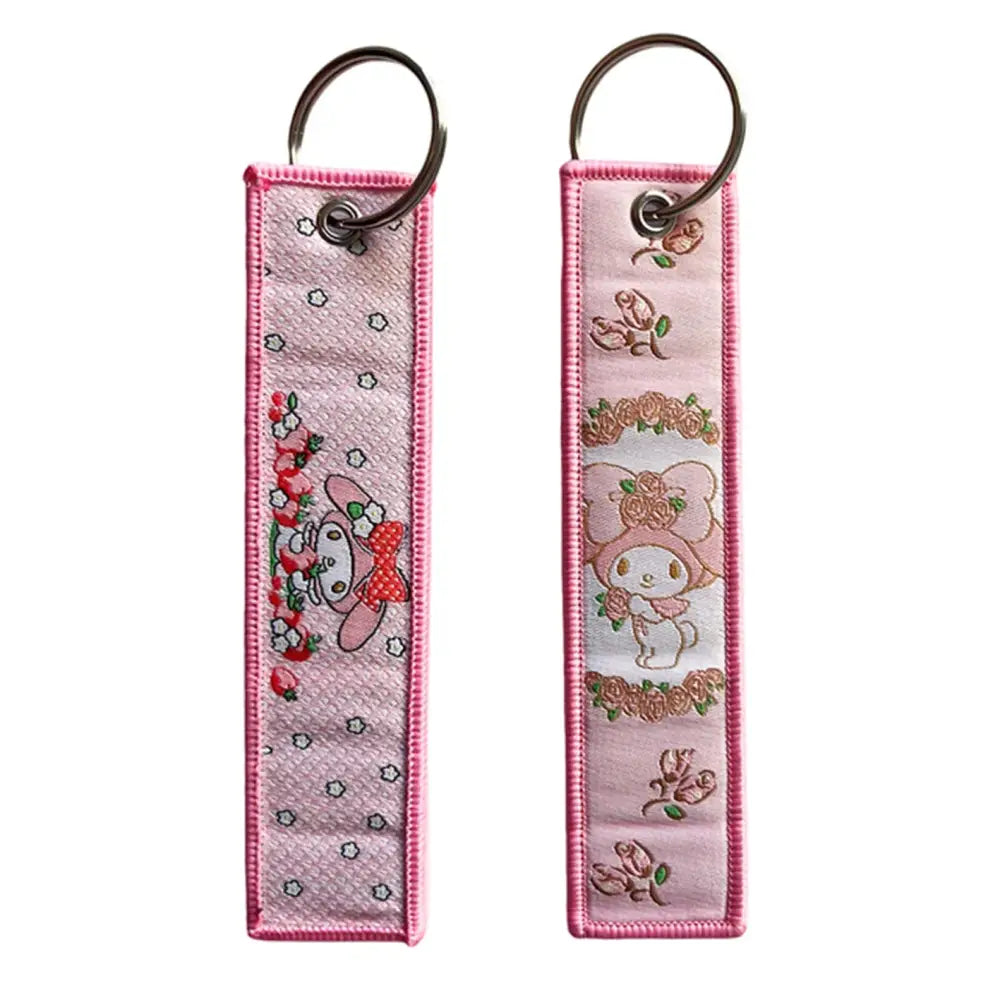 Pink embroidered anime lock keychain with cute my melody character floral designs and pink trim jet tag