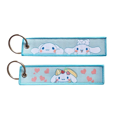 Light blue embroidered anime lock keychain featuring two cinnamoroll characters with pink hearts and metallic ring