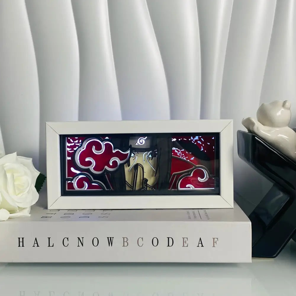 White framed naruto akatsuki themed led paper carving light box with red cloud motifs and stylized character figure