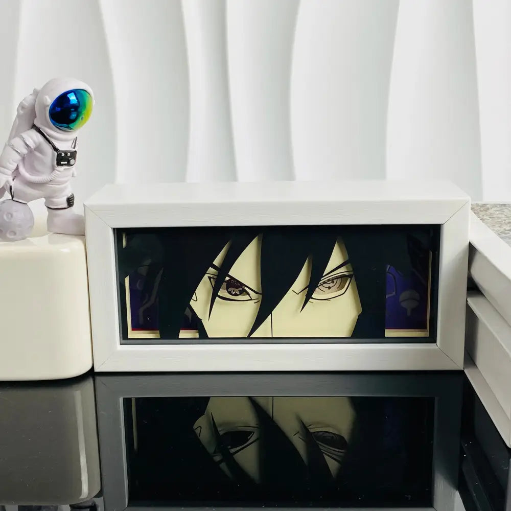 White framed anime manga 3d led paper carving light box featuring a glowing sasuke uchiha portrait on dark background