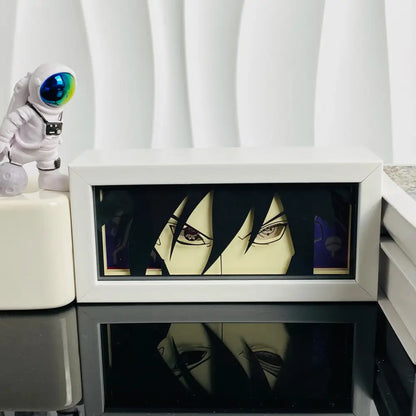 White framed anime manga 3d led paper carving light box featuring a glowing sasuke uchiha portrait on dark background