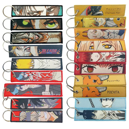 A collection of embroidered anime manga keychains with metal rings designed as badge holder usb pendants