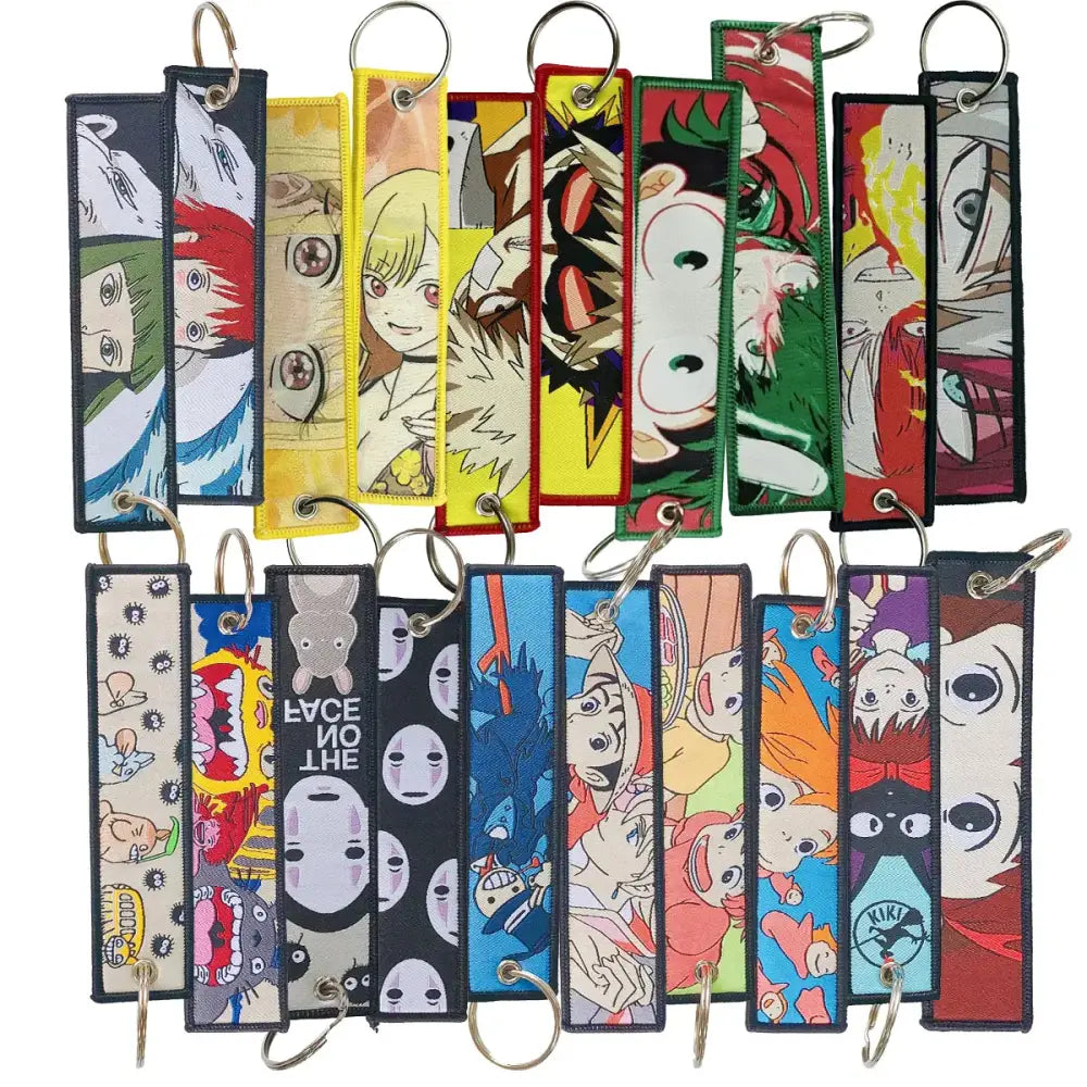 A collection of colorful anime manga badge holder usb pendants featuring embroidered fabric keychains with metal rings