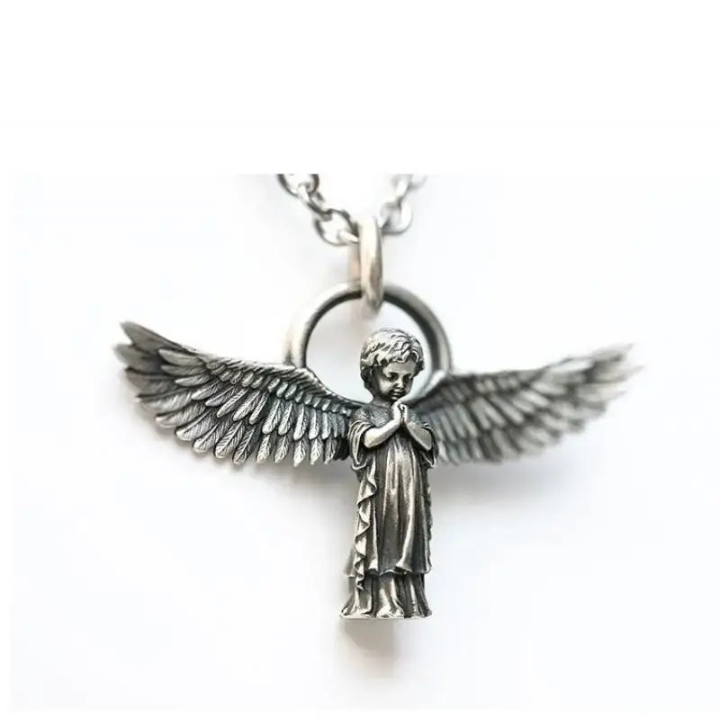 Silver pendant necklace featuring a silver angel pendant with detailed wings and clasped hands on a chain