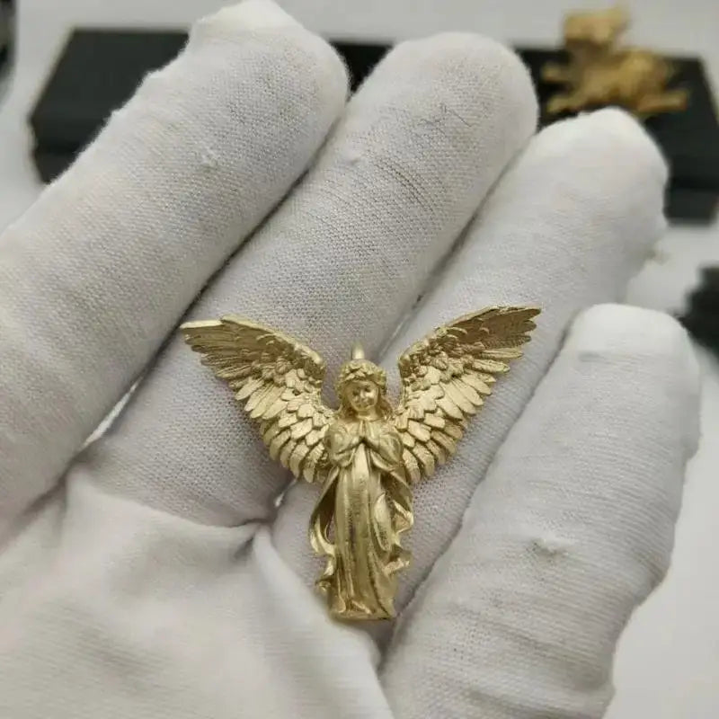 Gold angel pendant necklace with outstretched wings held in gloved hand for anime mecha girl silver pendant necklace