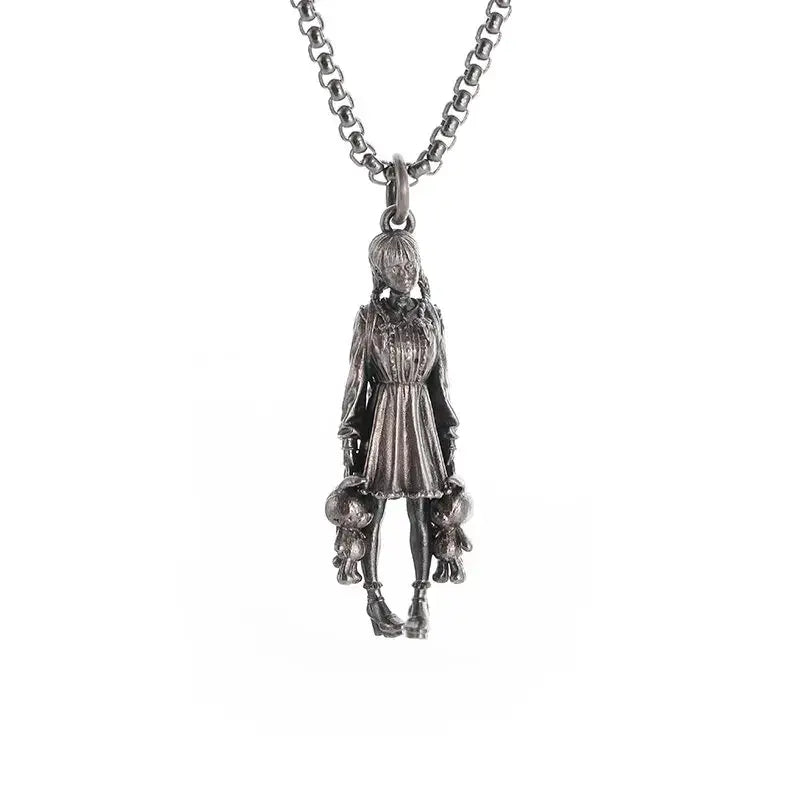 Silver pendant necklace featuring a detailed anime mecha girl figurine holding two small stuffed animals in a dress