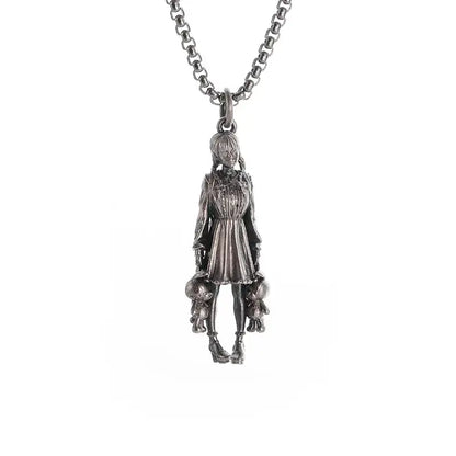 Silver pendant necklace featuring a detailed anime mecha girl figurine holding two small stuffed animals in a dress