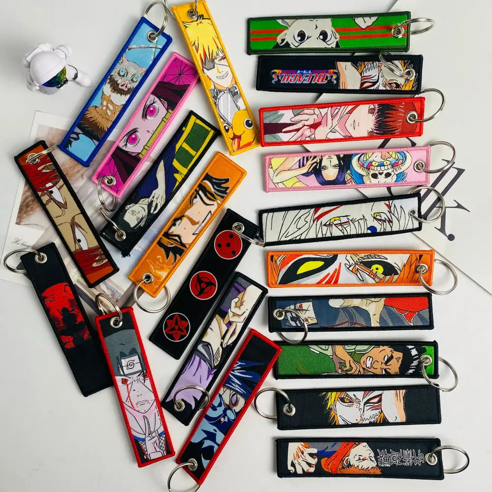 Colorful anime mix character jet tag keychain set with embroidered designs and metal rings for easy attachment