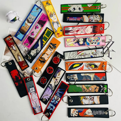 Colorful anime mix character jet tag keychain set with embroidered designs and metal rings for easy attachment