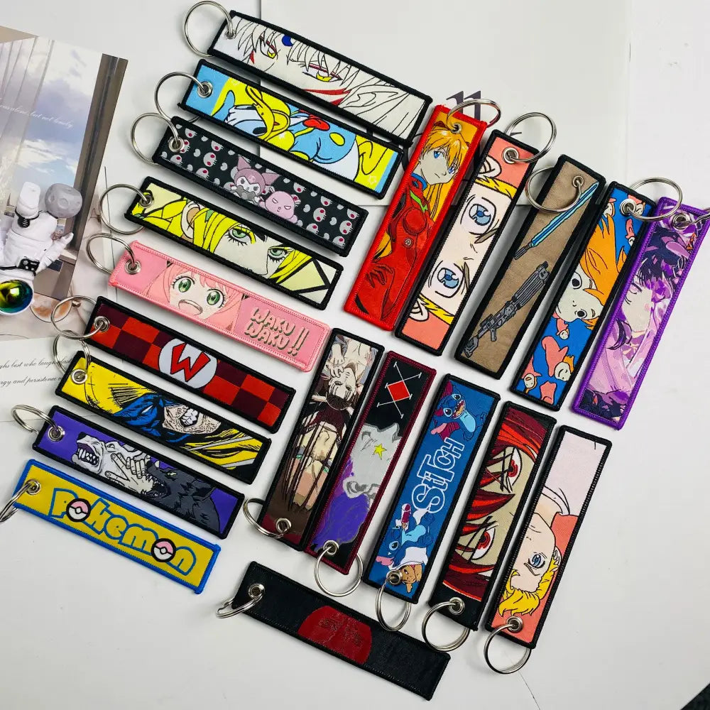 Colorful anime mix character jet tag keychain set with embroidered fabric designs and metal rings for easy attachment