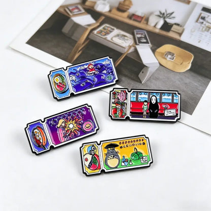 Four colorful rectangular enamel pin set featuring vintage movie ticket designs with studio ghibli illustrations