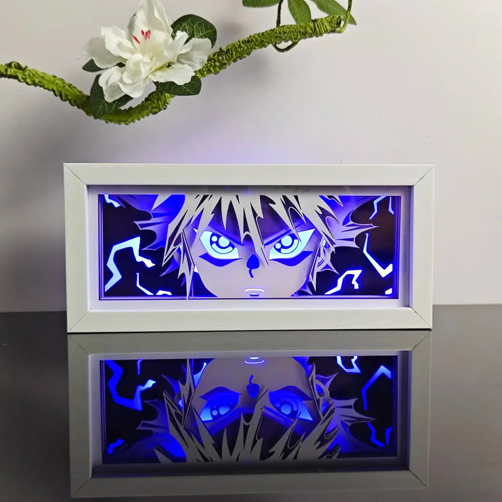 White-framed illuminated anime night light box with 3d laser led lamp featuring glowing blue eyes and spiky hair design