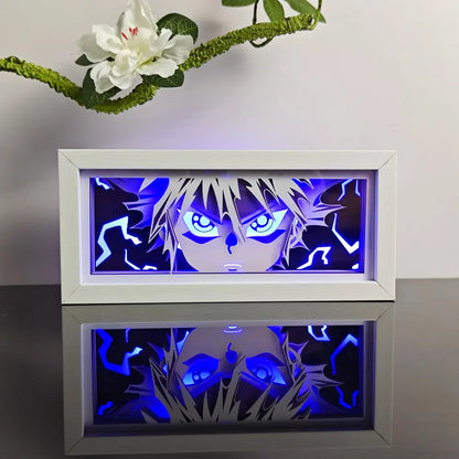 White-framed illuminated anime night light box with 3d laser led lamp featuring glowing blue eyes and spiky hair design