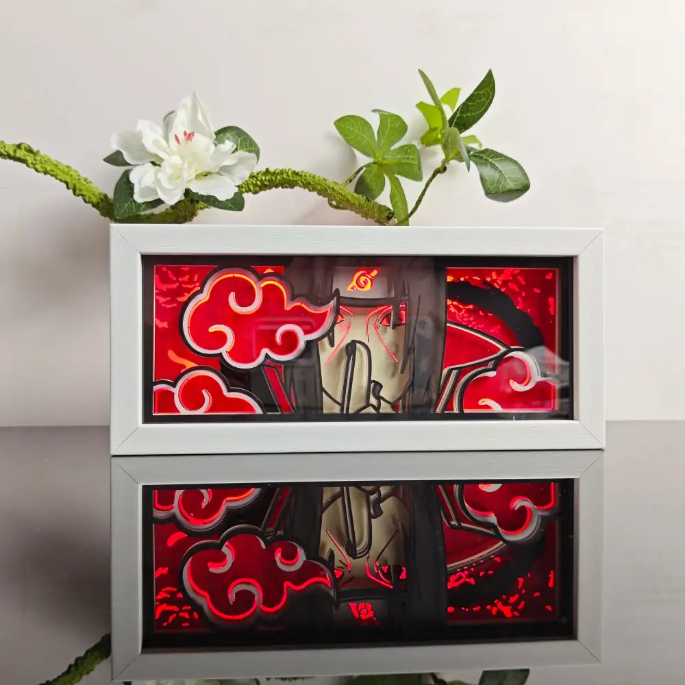 White-framed illuminated naruto uzumaki paper-cut led light box with glowing red cloud motifs and a red backlight