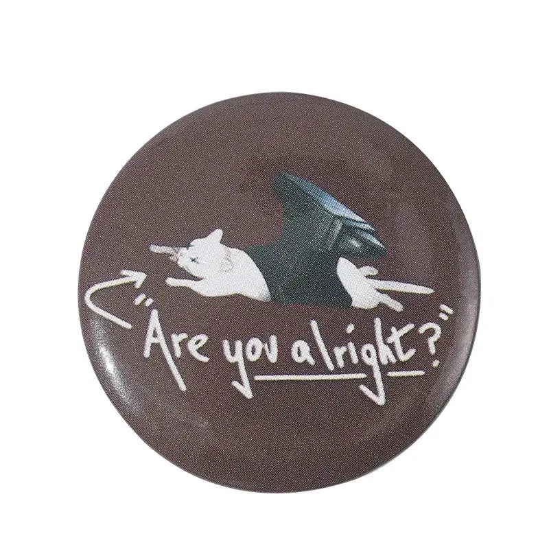 Brown circular anime pin brooch with white cartoon cat and black wings made of durable tinplate with pin backing