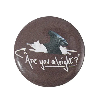 Brown circular anime pin brooch with white cartoon cat and black wings made of durable tinplate with pin backing