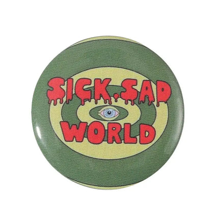 Olive green anime pin brooch with bold red text and blue eye design on durable tinplate with pin backing