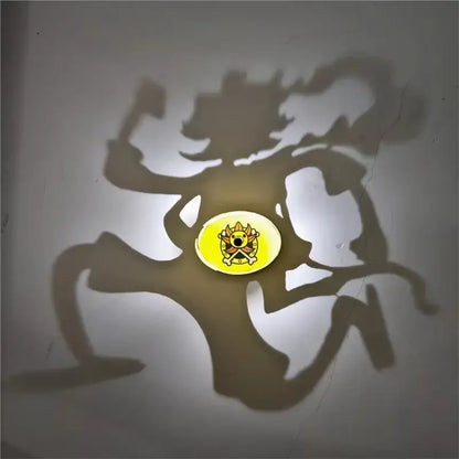 Yellow circular anime shadow projector lamp with cartoon crown skull design casting an animated kaito kid shadow