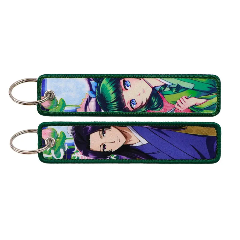 Two rectangular embroidered maomao key chains with green border and silver metal key ring from apothecary diaries