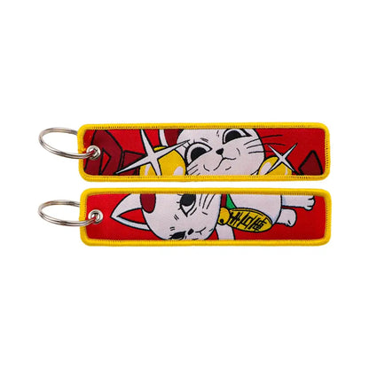 Red and yellow embroidered maomao key chain featuring a cartoon maneki-neko cat design with metal key ring