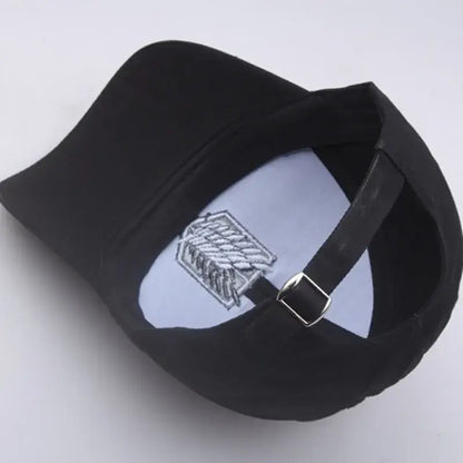 Black baseball hat featuring silver embroidered titan wings logo with adjustable strap for attack on titan fans