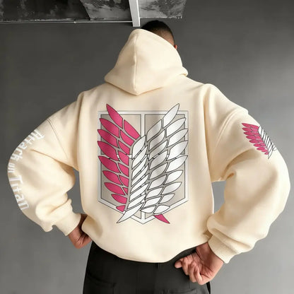 Back side of a cream-colored attack on titan wings oversized hoodie with pink and white winged emblem and sleeve patches