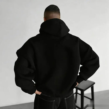 Black oversized attack on titan wings hoodie with relaxed fit and ribbed cuffs unisex print front view