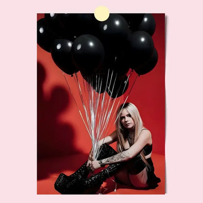 A cluster of glossy black balloons with reflective white dots tied by silver strings on an avril lavigne wall poster