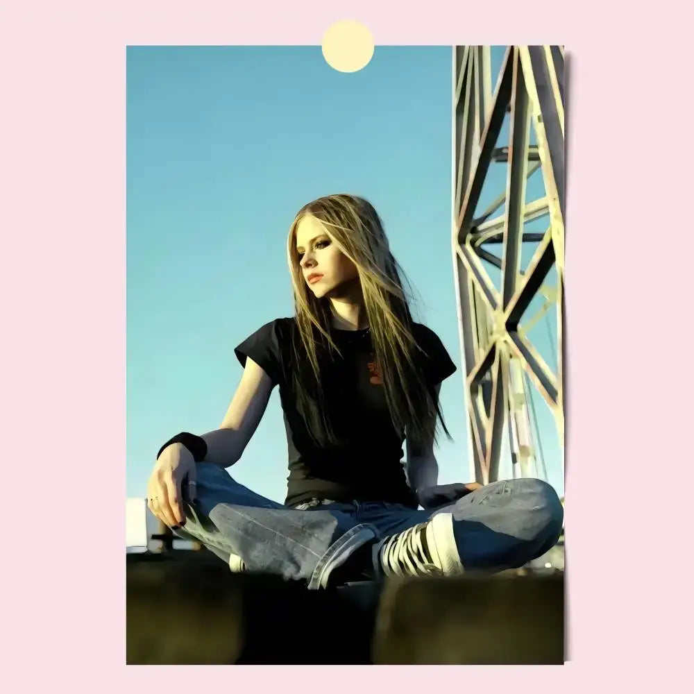 Avril lavigne wall poster featuring a woman with long blonde hair sitting cross-legged in blue jeans against clear sky