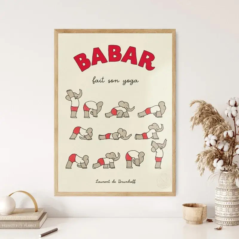 A framed canvas art featuring red and gray cartoon babar elephant family doing yoga poses for nursery decor