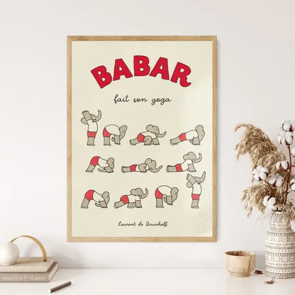 A framed canvas art featuring red and gray cartoon babar elephant family doing yoga poses for nursery decor