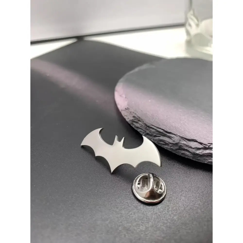 Silver batman symbol lapel pin with sleek metallic finish made of stainless steel enamel