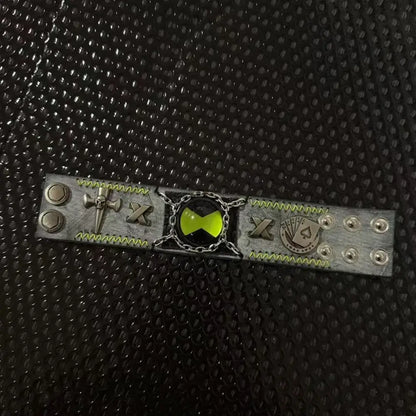 Silver-toned leather ben 10 omnitrix cosplay bracelet with glowing green emblem skull and playing card motifs